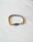 Person trying on a vintage bracelet with lapis stone on a white background