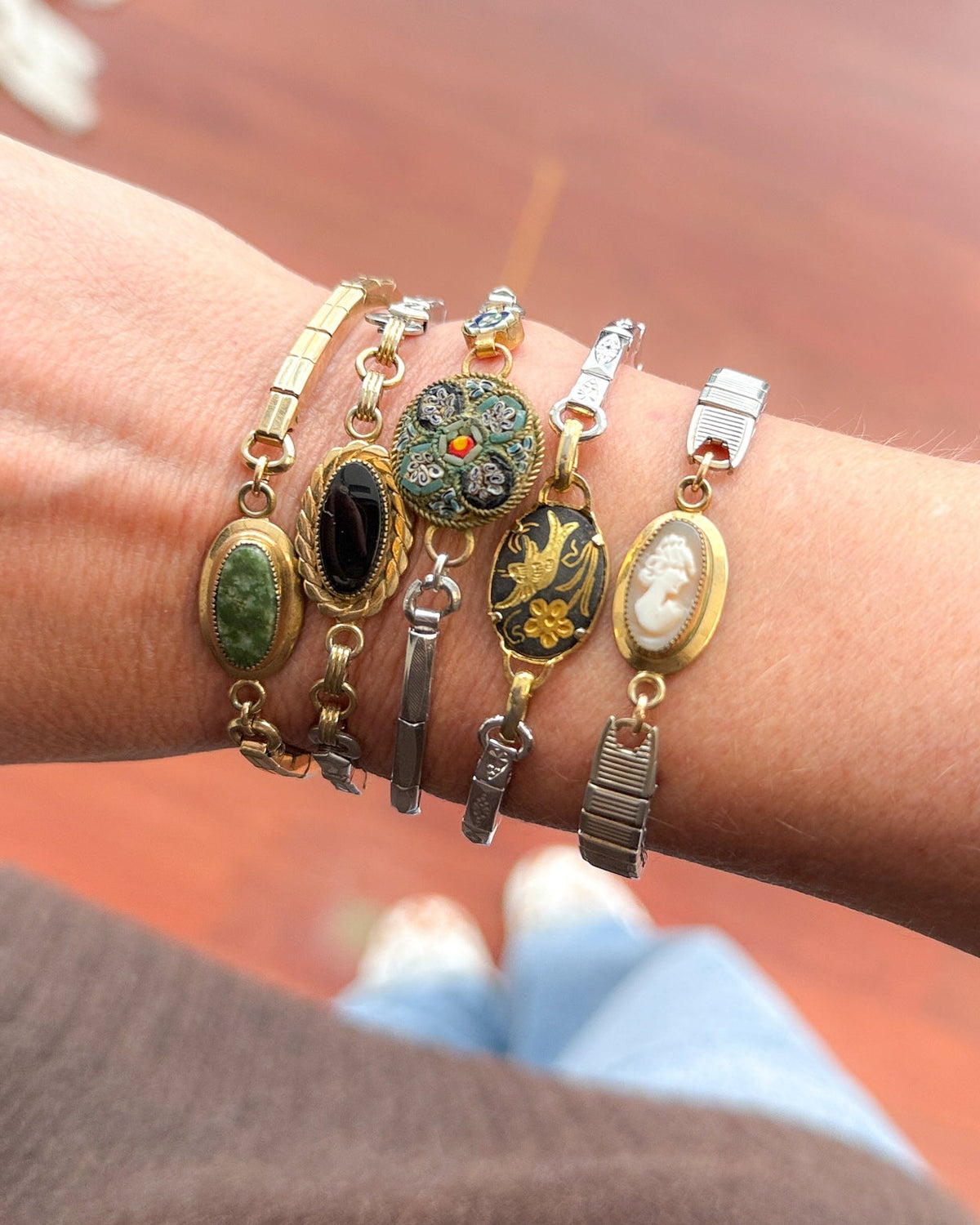 Woman wearing vintage onyx bracelet made from reclaimed watch band — elegant small-business jewelry gift.