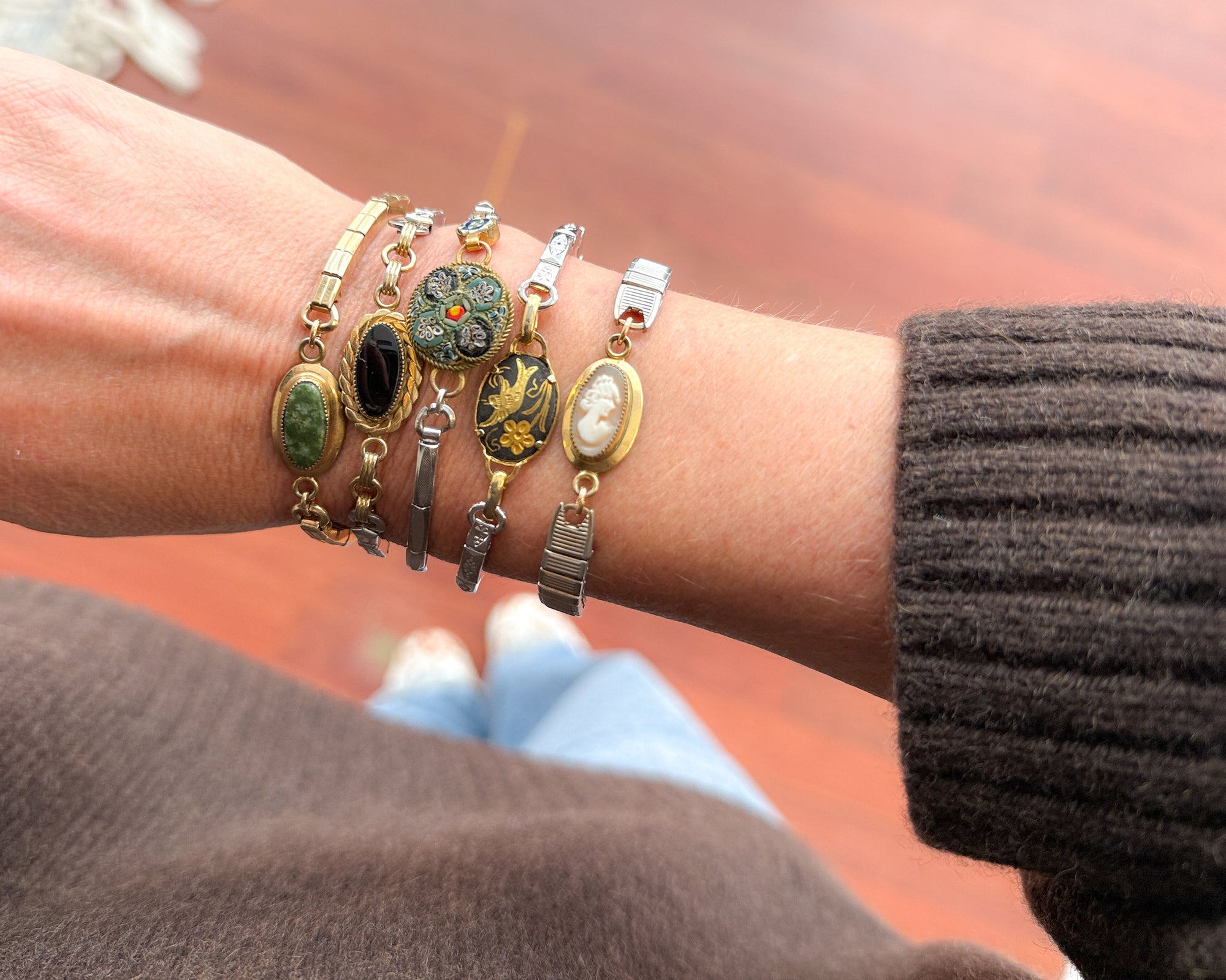 Woman wearing vintage onyx bracelet made from reclaimed watch band — elegant small-business jewelry gift.